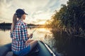 Cute woman is fishing with rod on a summer lake Royalty Free Stock Photo