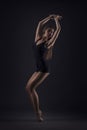 Cute woman gymnast on dark background