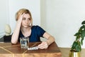 Cute woman holding her head and looking at a glass of water and pills. To feel bad. Coronavirus disease, covid-19. Feel sick Royalty Free Stock Photo