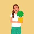 Cute woman is holding a pot with a home plant. Hobby to grow indoor plants