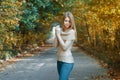 Cute woman in a jersey standing in autumn park