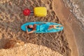 Cute woman lay on surfboard, suitcase and hat on sand. Desire of adventure, summer time, surf and holiday trip idea Royalty Free Stock Photo