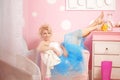 Cute woman looks like a doll in a sweet interior. Young pretty s Royalty Free Stock Photo