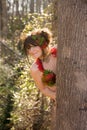 Cute Woman Peeking Out From Behind Tree