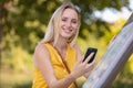 cute woman reading pleasant text message on mobile phone
