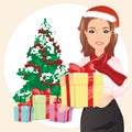 Cute woman in the red hat holding a gift in hands on the background of a Christmas tree and gifts