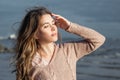 Cute woman relaxing outdoors. Pretty model girl with brown curly hair, romantic portrait Royalty Free Stock Photo