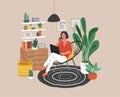 Cute woman sitting on chair with laptop in cozy scandinavian home interior. Girl working at home in home office. Daily Royalty Free Stock Photo