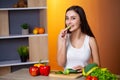 Cute woman slices cucumber for diet salad. Royalty Free Stock Photo