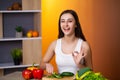 Cute woman slices cucumber for diet salad. Royalty Free Stock Photo