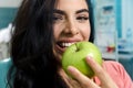 Cute, woman smiling and biting apple