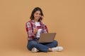 Cute woman speaking on mobile phone and holding credit card Royalty Free Stock Photo