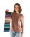 Cute woman in sweater holding fabric swatches Royalty Free Stock Photo