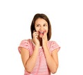 Cute woman talking on mobile phone, laughing with joy and happy, one hand covering the mouth. emotional girl on white bac Royalty Free Stock Photo
