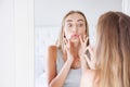 Cute woman touching her lips while looking in the mirror, beauty and skin care concept,wrinkles Royalty Free Stock Photo