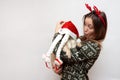 Cute woman in traditional red Christmas deer with funny pug dog in christmas hat Royalty Free Stock Photo