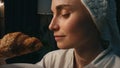 Cute woman trying croissant at dark place closeup. Hungry girl eating dessert