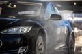 Cute woman washing her car in a manual carwash Royalty Free Stock Photo