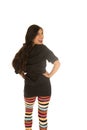 Cute woman wearing colorful leggings looking over her shoulder