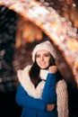 Winter Girl with Knitted Beanie and Scarf Enjoying Christmas