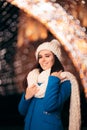 Winter Girl with Knitted Beanie and Scarf Enjoying Christmas