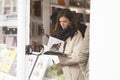 Cute women reading new book in book store