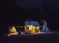 Cute wooden painted yellow private children`s play house in home garden decorated with Christmas LED string lights outdoors in c