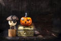 Cute wooden pirate ghost and smiling halloween pumpkin on treasure box