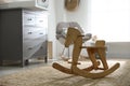 Cute wooden rocking horse in baby room