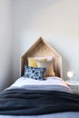 Cute wooden tent style wooden bedhead in a styled children`s bed