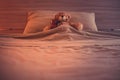 Cute wool teddy bear is lying in the bed Royalty Free Stock Photo