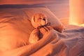 Cute wool teddy bear is lying in the bed Royalty Free Stock Photo