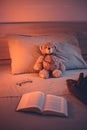 Cute wool teddy bear is lying in the bed Royalty Free Stock Photo