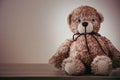 Cute wool teddy bear is lying on the table Royalty Free Stock Photo