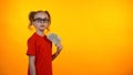 Cute wunderkind girl holding bunch of dollar cash, nerd winning grant, income Royalty Free Stock Photo