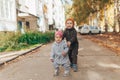 Cute 1 year old baby girl and 3 years old boy walking outdoors wearing in stylish overalls Royalty Free Stock Photo