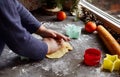 A cute 3-4 year old girl makes her own Christmas cookies. Family vacation at home during the holidays. Flour and dough Royalty Free Stock Photo