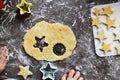A cute 3-4 year old girl makes her own Christmas cookies. Family vacation at home during the holidays. Flour and dough Royalty Free Stock Photo