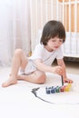 Cute 2 years boy with brush and gouache paints at home Royalty Free Stock Photo