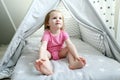 Cute 2 years little girl in wigwam tent Royalty Free Stock Photo