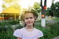 Cute 6-7 years old girl in crown of daisy flowers Royalty Free Stock Photo