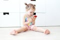 Cute 2 years toddler girl with mobile phone at home