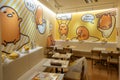 Cute yellow interior dining area inside a Gudetama Cafe at Osaka City. It is a very popular Sanrio character