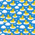 Cute yellow rubber ducks float on fluffy white clouds in a repeating seamless pattern set against a bright blue sky background Royalty Free Stock Photo