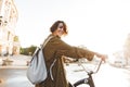 Cute young amazing woman walking outdoors in park with bicycle beautiful spring day