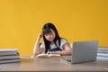 A cute young Asian girl focusing on reading a book at her study table. learning, knowledge Royalty Free Stock Photo