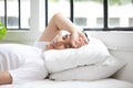 Cute young Asian man sleeping on bed in the morning resting peacefully in comfortable bed, lying with closed eyes Royalty Free Stock Photo