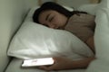 Cute Young Asian Woman Laying On The Bed While Holding The Switch On An Open Light Smartphone In Hand And Asleep, Nap With Tired