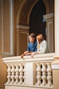 Cute young beautiful hipster couple travelling Europe, standing at the Opera House balcony Royalty Free Stock Photo