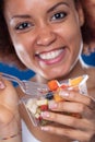 Cute young Black woman eating a fresh fruit salad Royalty Free Stock Photo